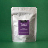 Envase Doypack plateado de Guisante de Mariposa Amman Tea Blends con etiqueta morada, adelgazante y relajante, sobre fondo verde.